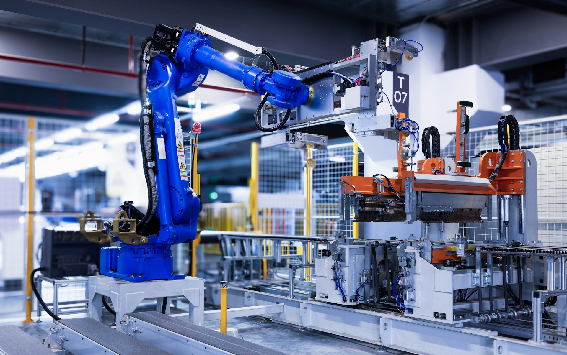 Factory worker handling sheet metal in a plant managed with Odoo ERP