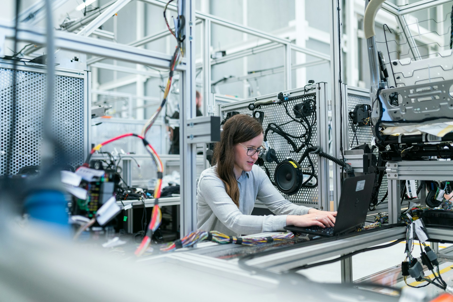Factory worker welding metal on a manufacturing line run with Odoo